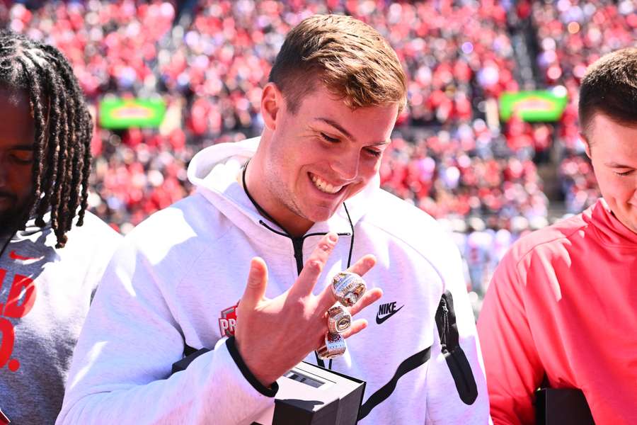 Former Ohio State quarterback Will Howard reacting to his championship rings