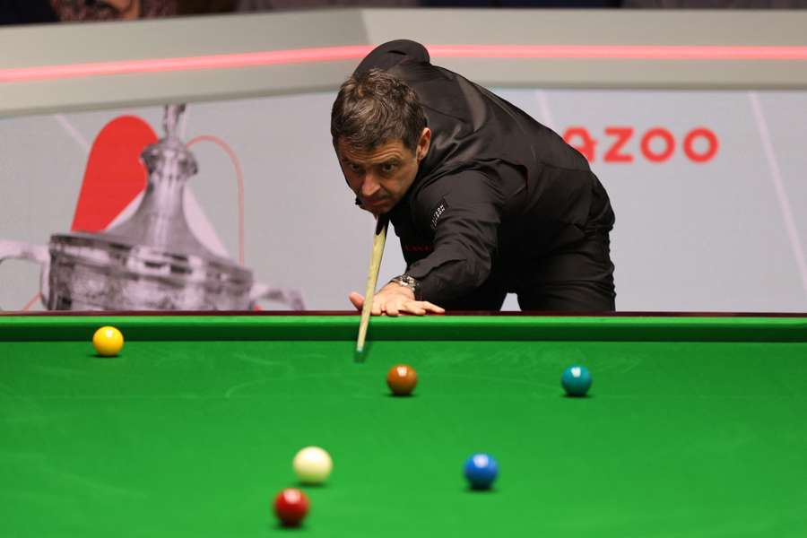 Ronnie O'Sullivan of England plays a shot against Ryan Day of Wales in their round two match 