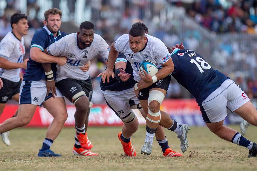 Fiji's Samuel Matavesi evades a tackle of Scotland's Will Hurd