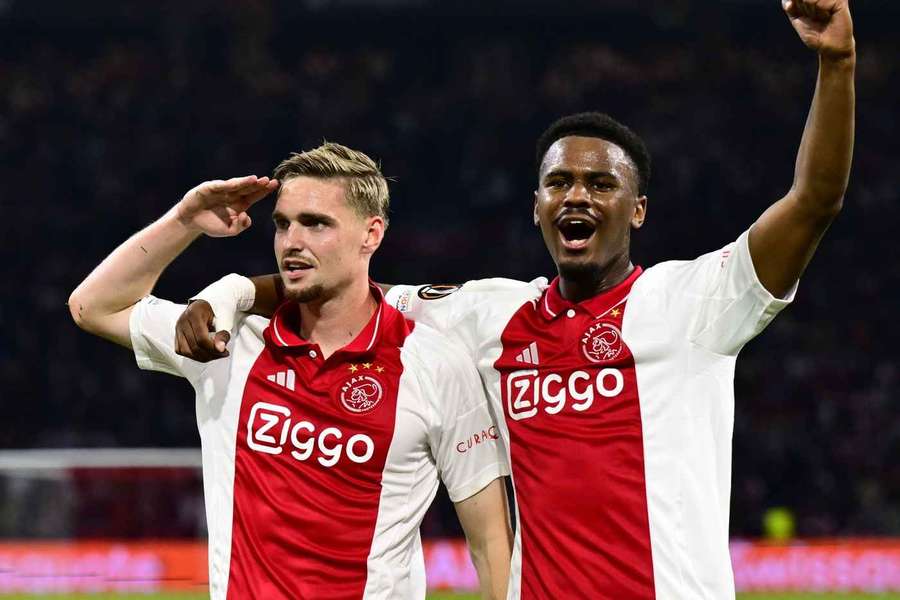 Ajax's Jorrel Hato (R) celebrates team-mate Kenneth Taylor's goal against Besiktas in the UEFA Europa League