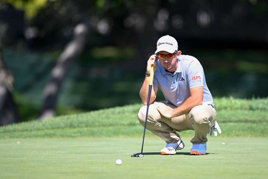 Herbert watches on at the 14th hole