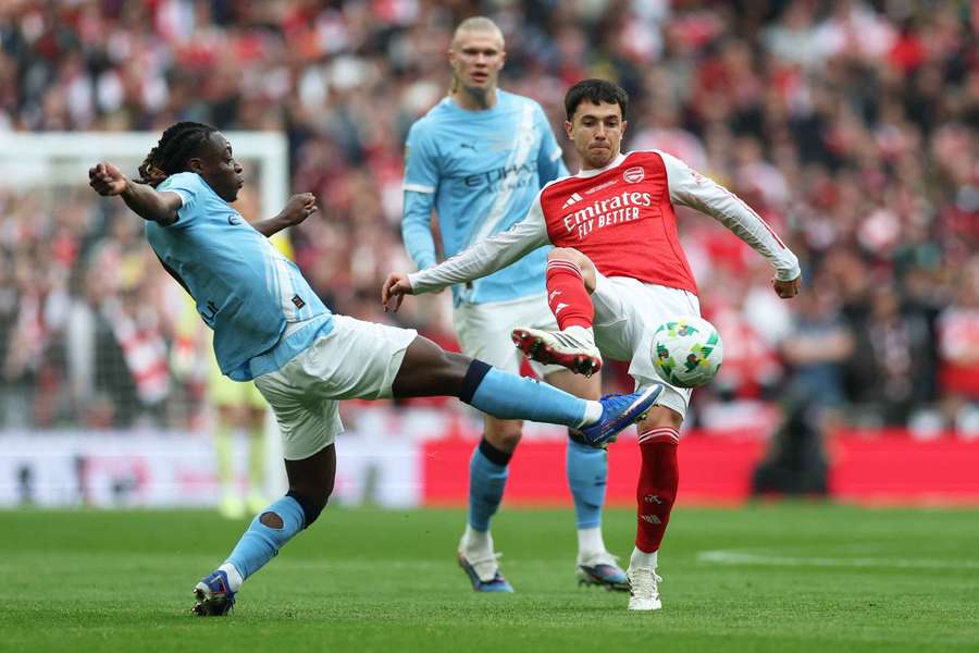 Manchester City's Jeremy Doku in action with Arsenal's Martin Zubimendi