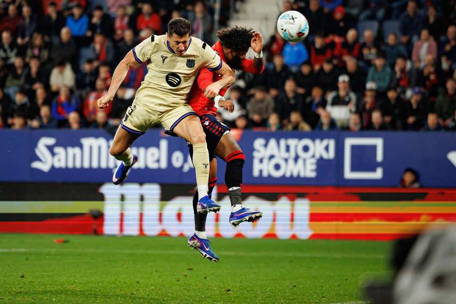 Barcelona's Robert Lewandowski and Osasuna's Valentin Rosier challenge for the ball Barcelona's Robert Lewandowski and Osasuna's Valentin Rosier challenge for the ball