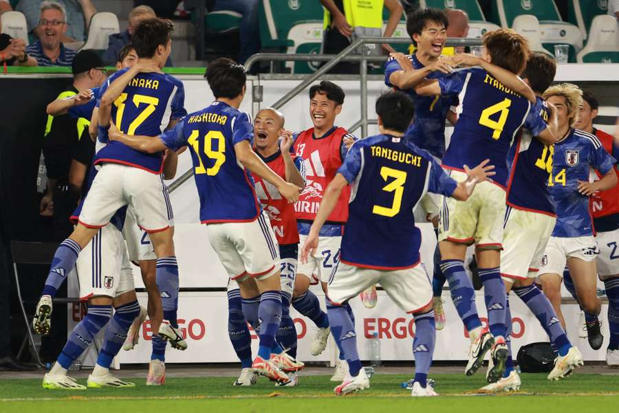 Japan celebrate their win against Germany