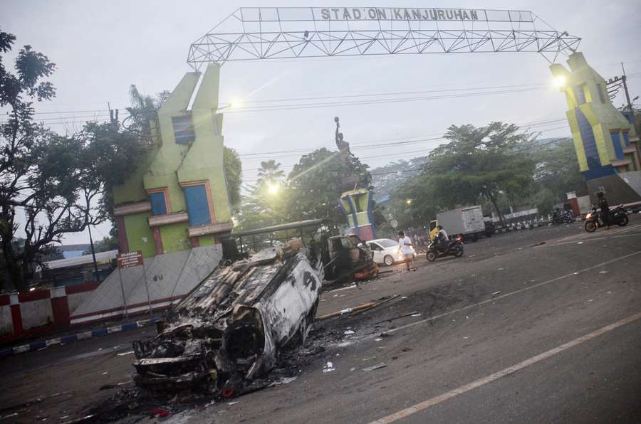 A torched car is pictured outside the Kanjuruhan stadium in Malang, East Java on October 2, 2022.