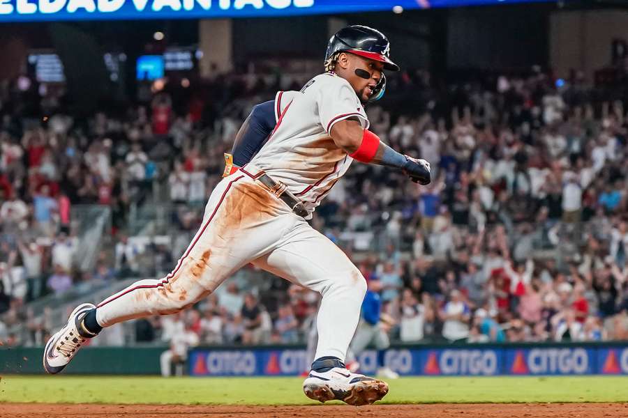Ronald Acuna Jr. rounds third base on his way to scoring a run against the Chicago Cubs during the eighth inning