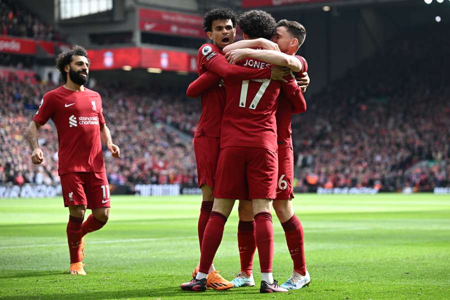 Liverpool's English midfielder Curtis Jones celebrates with teammates after scoring the opening goal of the English Premier League football match between Liverpool and Tottenham