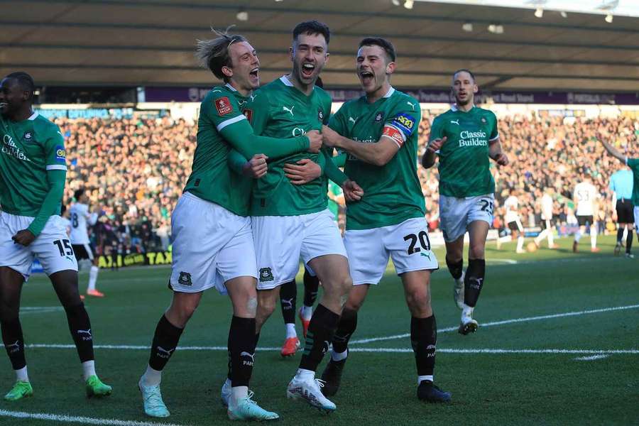 Ryan Hardie celebrates with teammates after scoring the decisive penalty