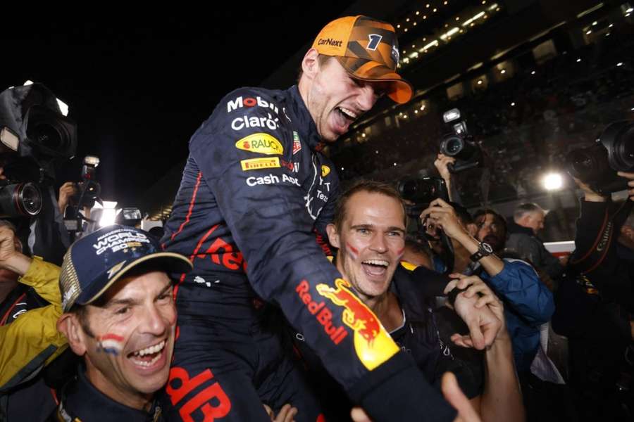 Max Verstappen celebrates winning the championship with his team.