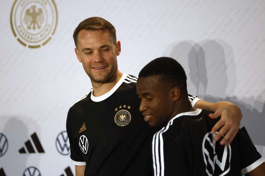 Manuel Neuer with teammate Youssoufa Moukoko at a press conference at the World Cup