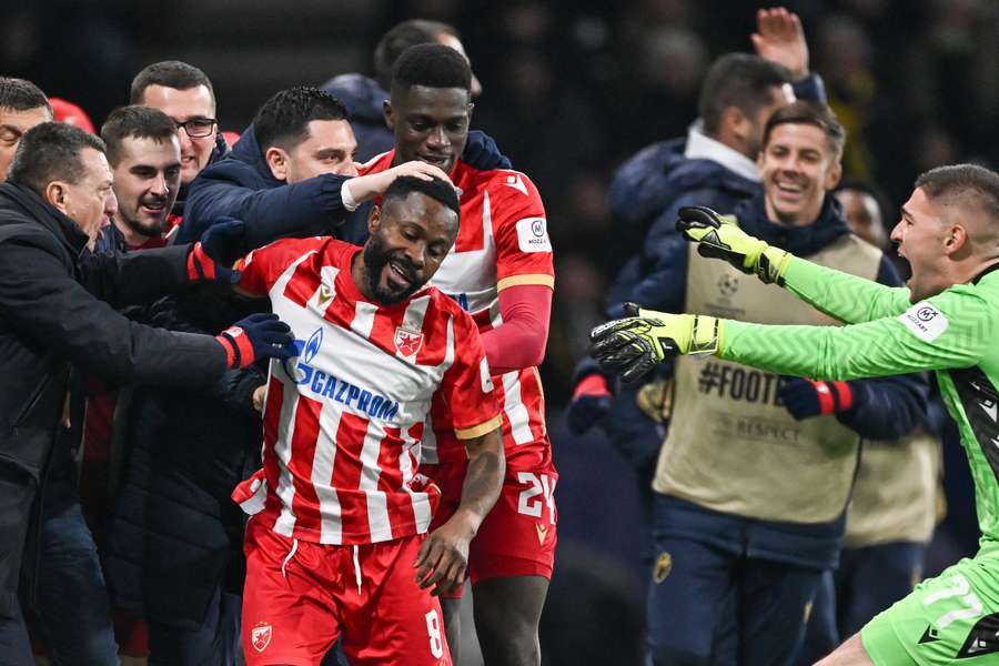 Guelor Kanga is mobbed by his teammates after scoring the winner