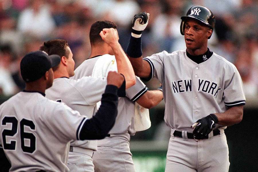New York Yankees Darryl Strawberry (R) receives congratulations from teammates after hitting a home run against the Anaheim Angels in 1998 New York Yankees Darryl Strawberry (R) receives congratulations from teammates after hitting a home run against the Anaheim Angels in 1998