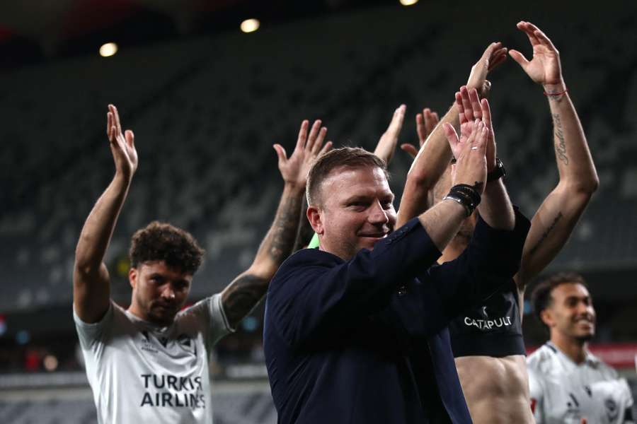Melbourne Victory manager Arthur Diles acknowledges the travelling fans in western Sydney.