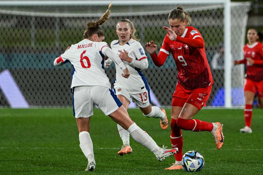 Switzerland's forward #09 Ana-Maria Crnogorevic (R) is tackled by Norway's defender #06 Maren Mjelde