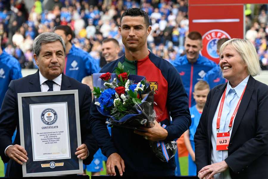 Cristiano Ronaldo is honoured with a certificate from the Guinness World Records before kick-off for making his 200th international cap