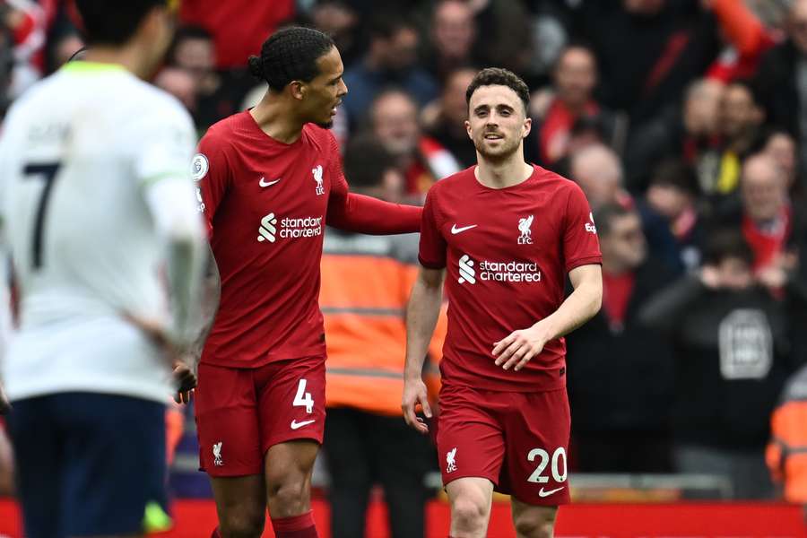 Liverpool's Portuguese striker Diogo Jota (R) smiles as he celebrate with Liverpool's Dutch defender Virgil van Dijk (L) after scoring their late fourth goal