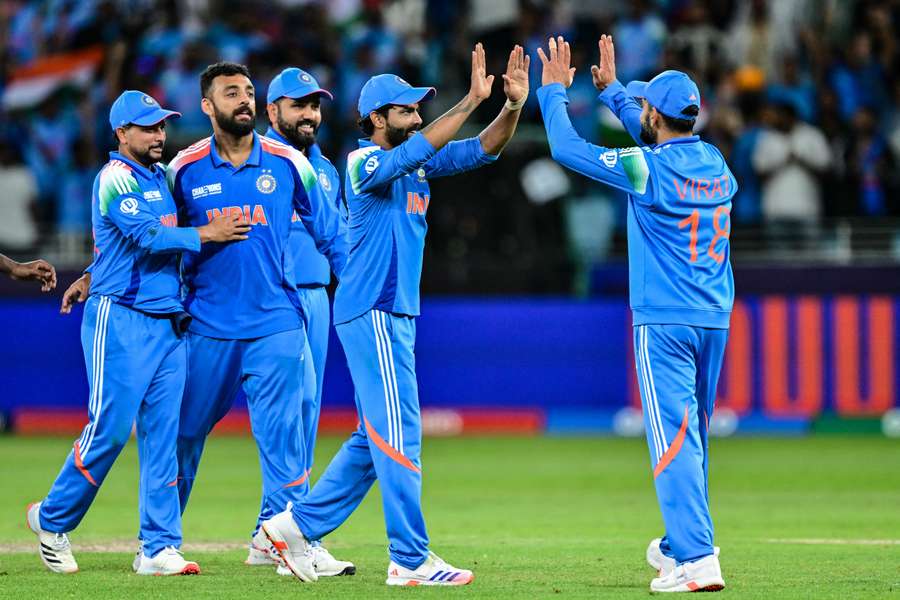 India's Virat Kohli (right) celebrates with teammates after taking a catch to dismiss New Zealand's Matt Henry