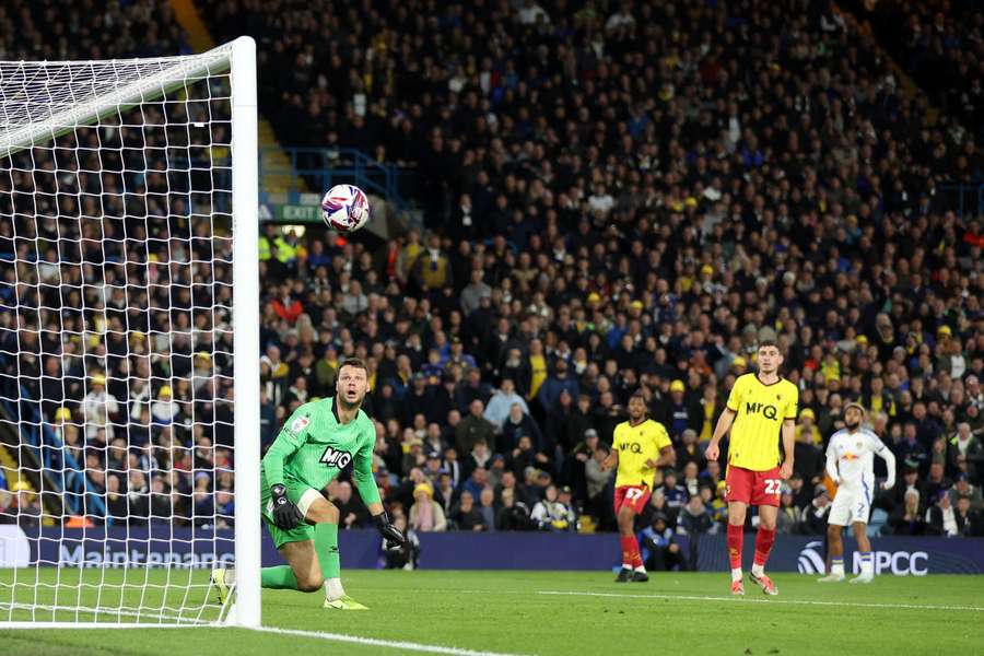 Watford goalkeeper Daniel Bachmann looks on as a shot from Jayden Bogle of Leeds United hits the post