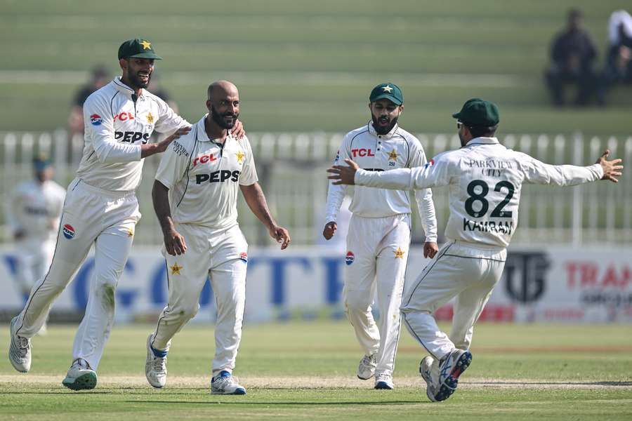 Pakistan's Sajid Khan celebrates with teammates after taking the wicket of England's Jamie Smith