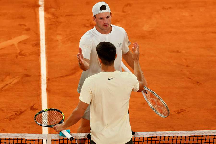 Tommy Paul and Carlos Alcaraz shake hands at the net