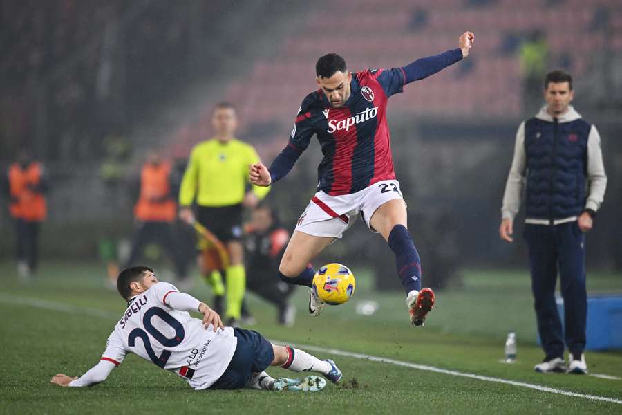 Charalampos Lykogiannis of Bologna is challenged by Stefano Sabelli of Genoa