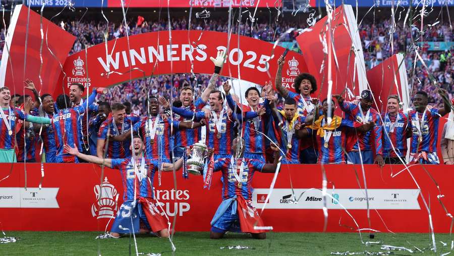 Crystal Palace players celebrate with the FA Cup trophy after their win against Manchester City at Wembley Stadium. Crystal Palace players celebrate with the FA Cup trophy after their win against Manchester City at Wembley Stadium.