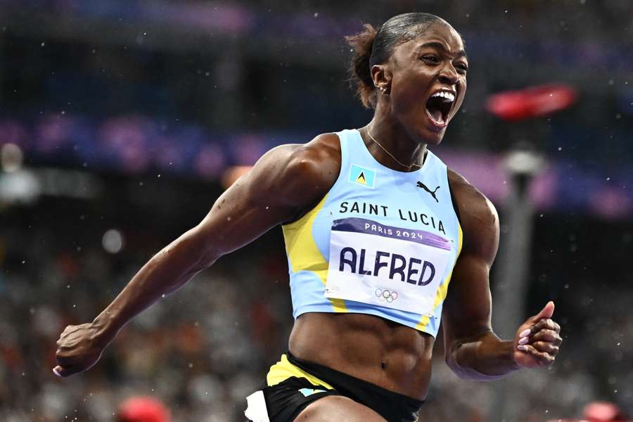 Julien Alfred celebrates winning the women's 100m final at the Olympic Games Paris 2024