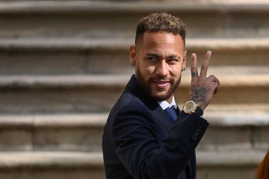 Neymar gestures as he leaves after attending a hearing at the courthouse in Barcelona on October 18, 2022