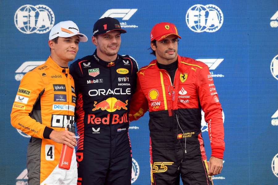 First placed Red Bull's Dutch driver Max Verstappen flanked by second placed Ferrari's Spanish driver Carlos Sainz Jr (R) and McLaren's British driver Lando Norris (L)