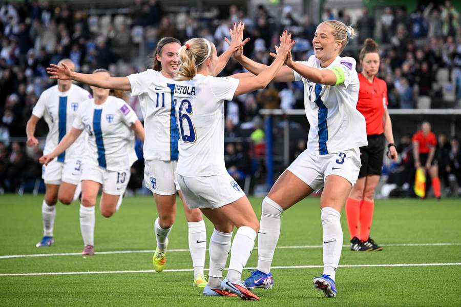 Finland celebrate their fourth goal against Slovakia