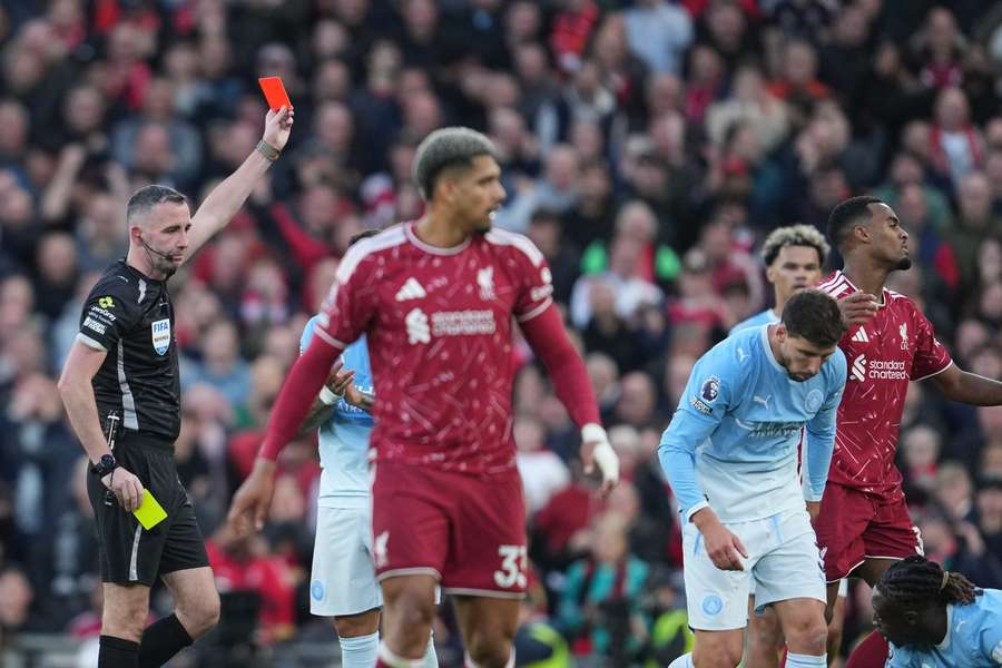 Referee Chris Kavanagh shows a red card to Liverpool's Ryan Gravenberch during the match against Manchester City