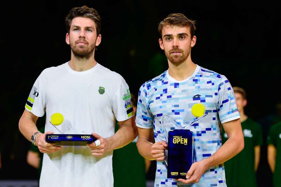 France's Benjamin Bonzi (R) holds his trophy next to Britain's Cameron Norrie after winning the Moselle Open final