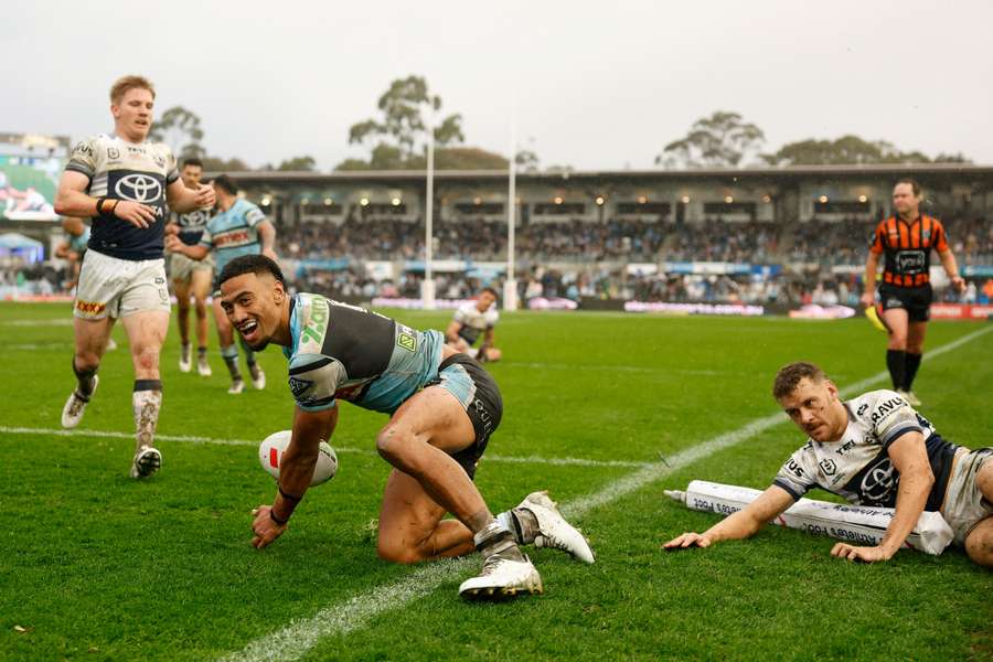 Cronulla Sharks winger Ronaldo Mulitalo celebrates a try against North Queensland on Sunday.
