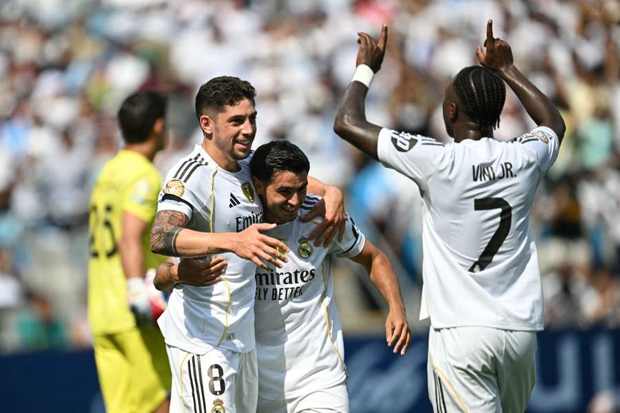 Real Madrid's Federico Valverde celebrates with teammates after scoring his team's third goal against Pachuca