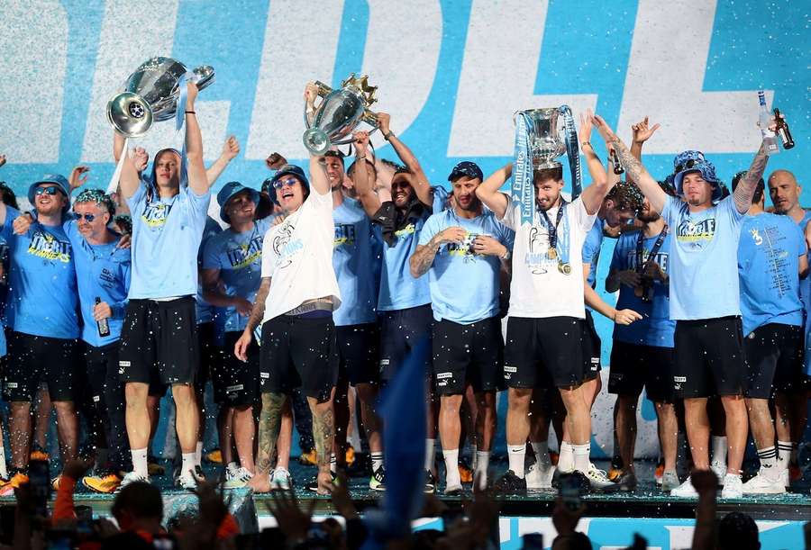City players celebrate with the three trophies