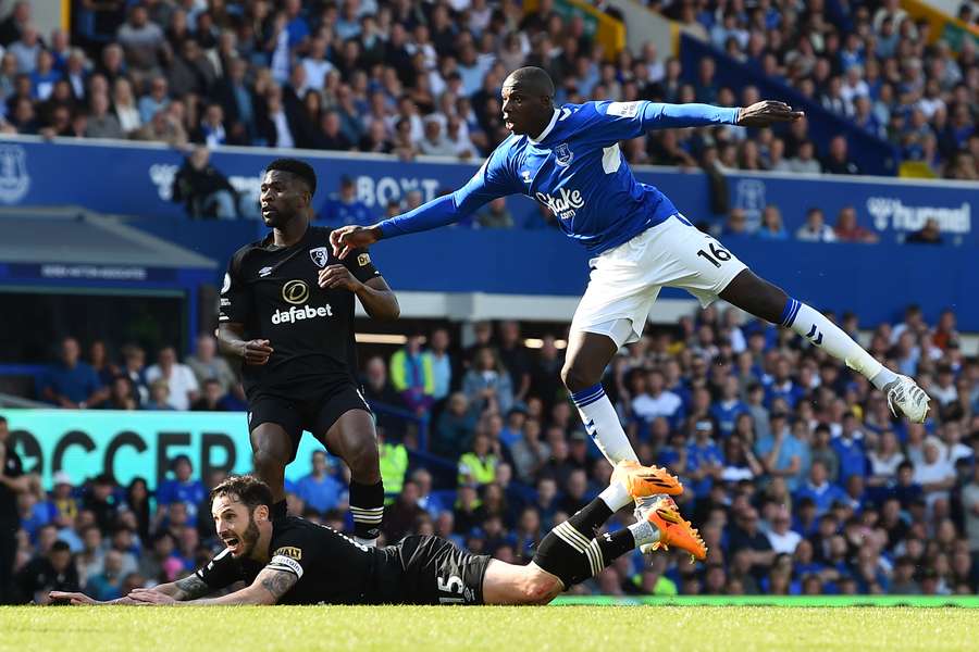 Everton's French midfielder Abdoulaye Doucoure (R) reacts as he scores his team's opening goal during the English Premier League football match between Everton and Bournemouth