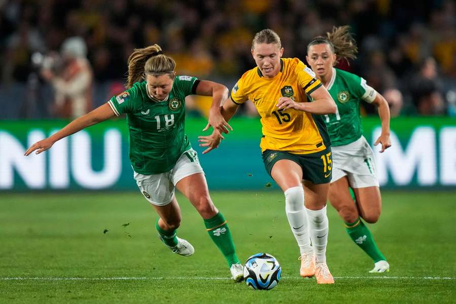 Clare Hunt bursts past two Irish defenders 