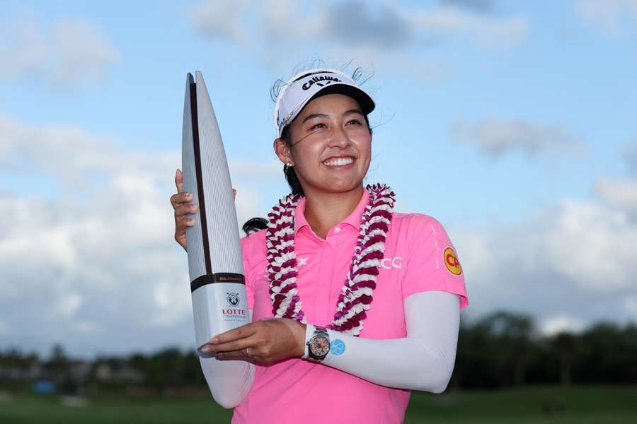 Jeeno Thitikul poses with the trophy after winning the Lotte Championship