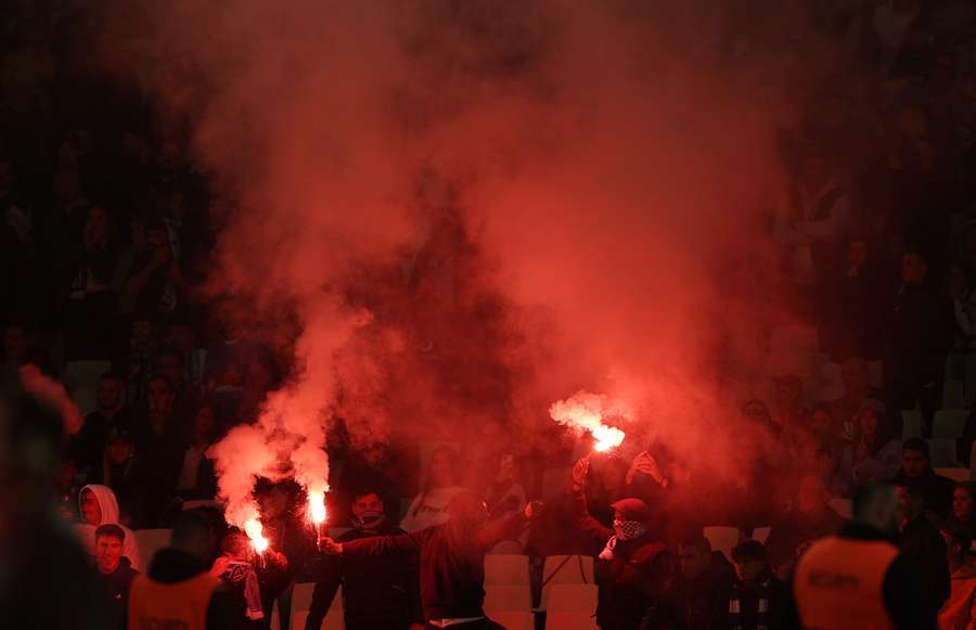 Greece fans with flares in the stands