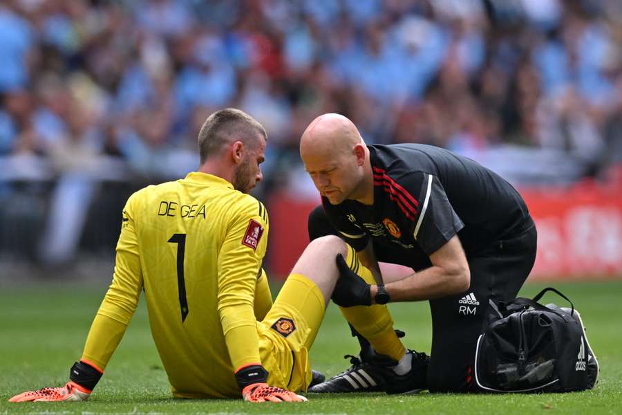 Manchester United goalkeeper David de Gea receives medical attention after picking up an injury