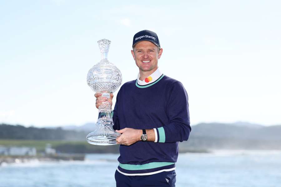 Justin Rose celebrates with the trophy