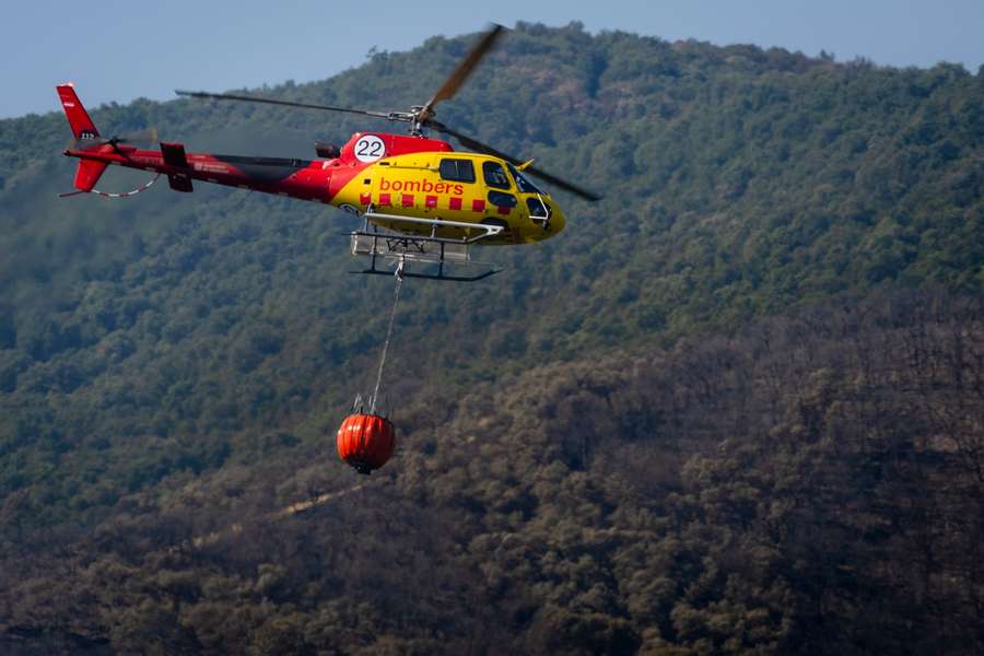 A fire department helicopter operates in an area near the town of Calonge, Catalonia, northeastern Spain A fire department helicopter operates in an area near the town of Calonge, Catalonia, northeastern Spain