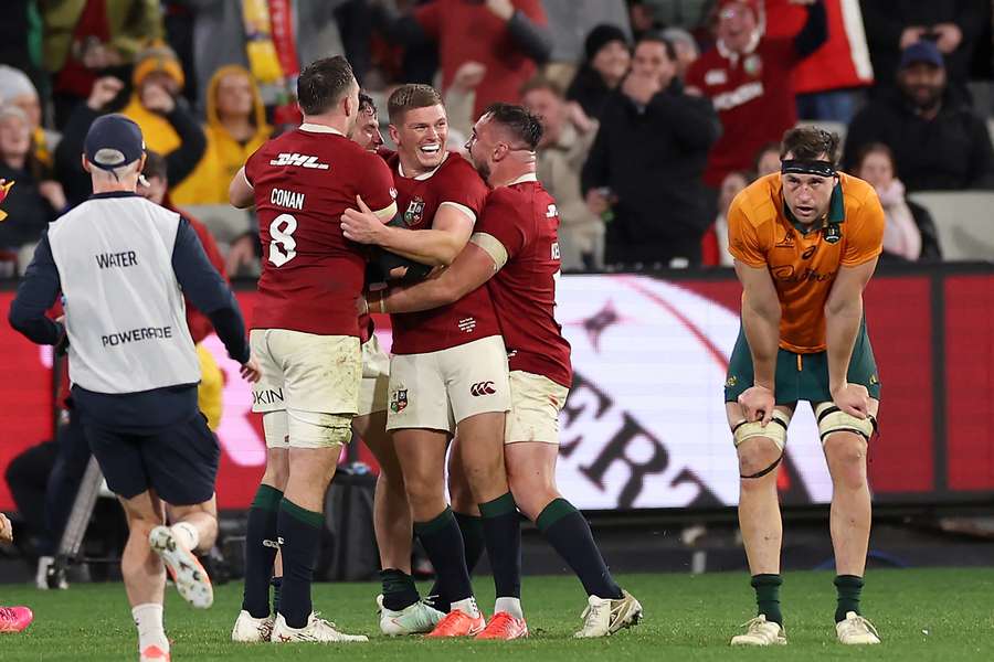 British and Irish Lions' Owen Farrell (C) celebrates a try by teammate Hugo Keenan against Australia