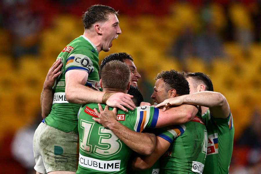 Morgan Smithies, Jamal Fogarty and Tom Starling celebrate the Raiders' stunning Magic Round win with teammates.