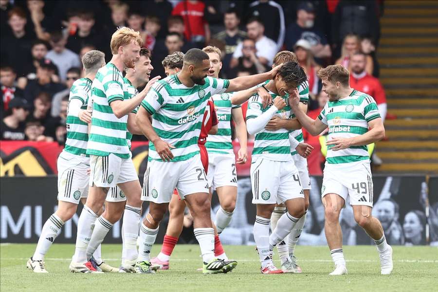 Reo Hatate celebrates with teammates after giving Celtic a two-goal lead over Aberdeen