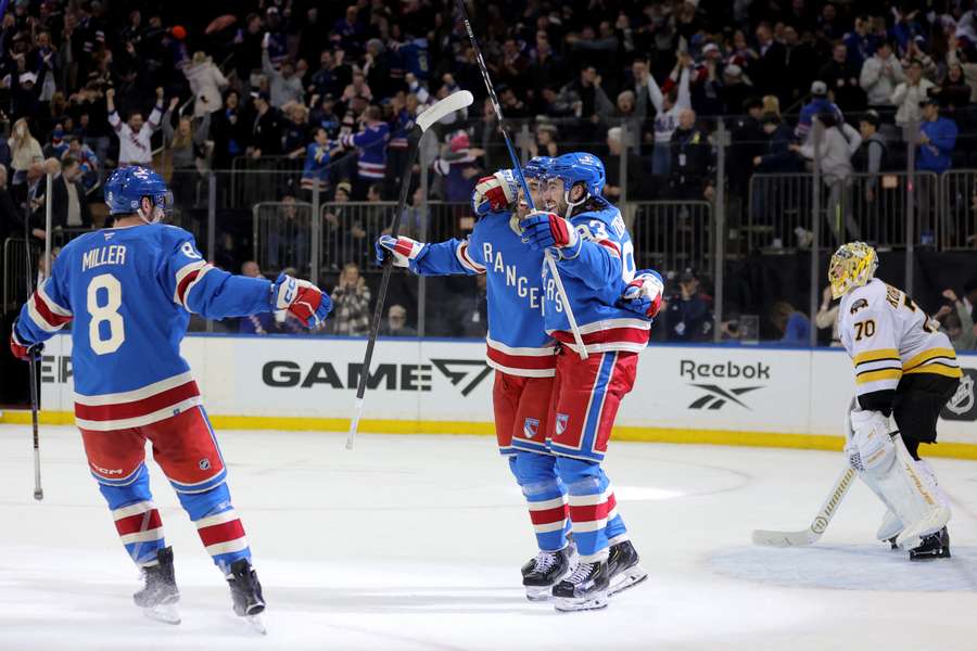 The New York Rangers celebrate a goal during their win over the Boston Bruins in the NHL.