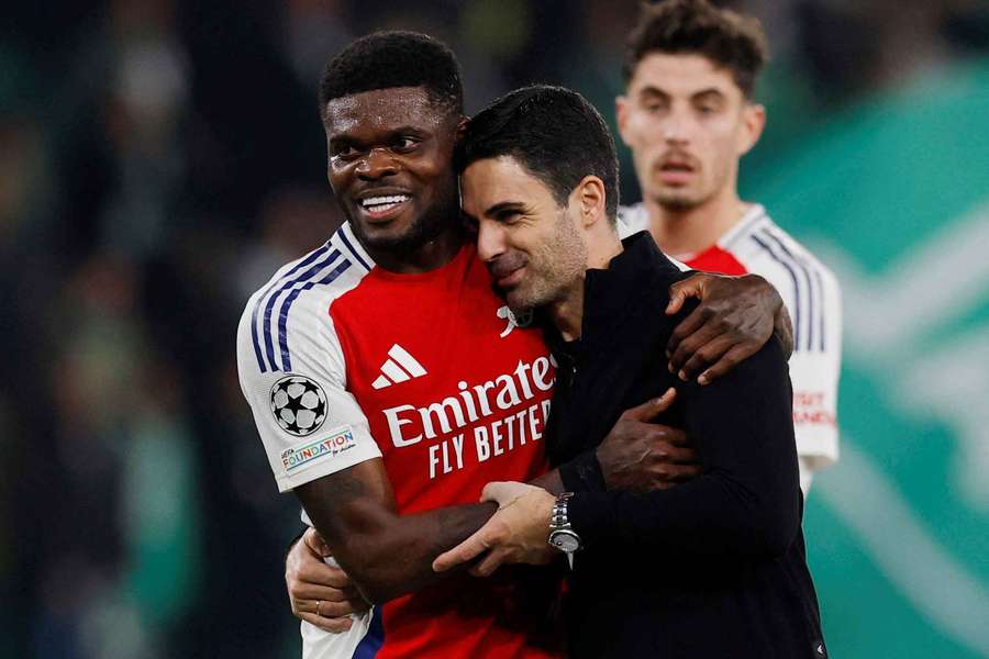 Arsenal coach Mikel Arteta embraces Thomas Partey after 5-1 win over Sporting