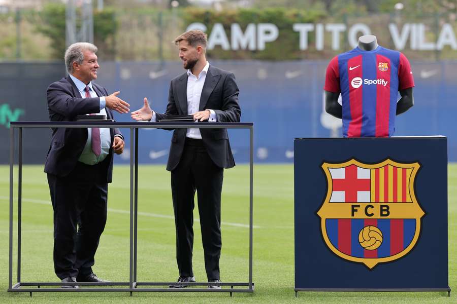 Inigo Martinez shakes hands with Barcelona's president Joan Laporta during his official presentation at the Joan Gamper training ground