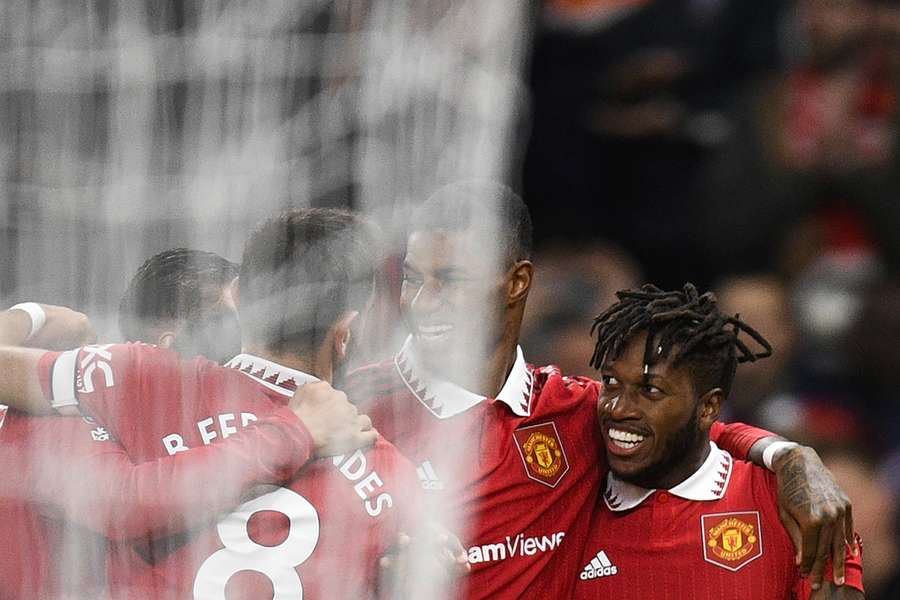 Fred celebrates with his team-mates after scoring