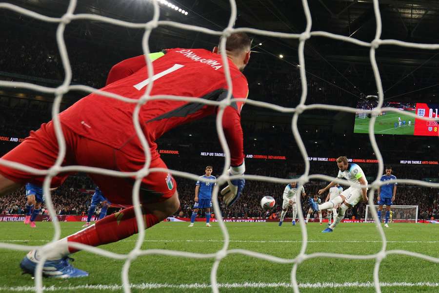 England's striker Harry Kane shoots a penalty kick and scores his team's first goal